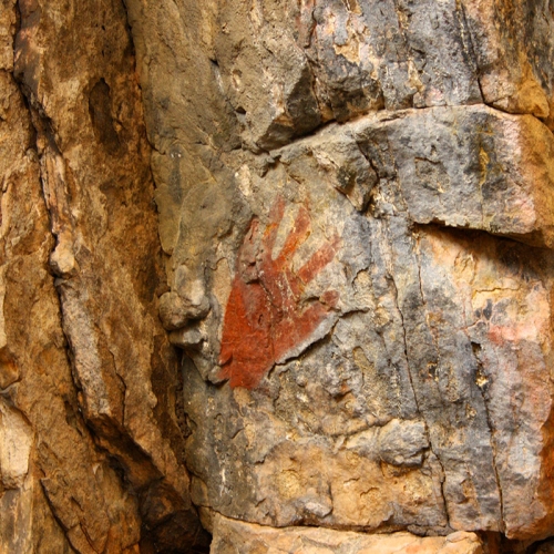 Red Hand Painting On A Rock